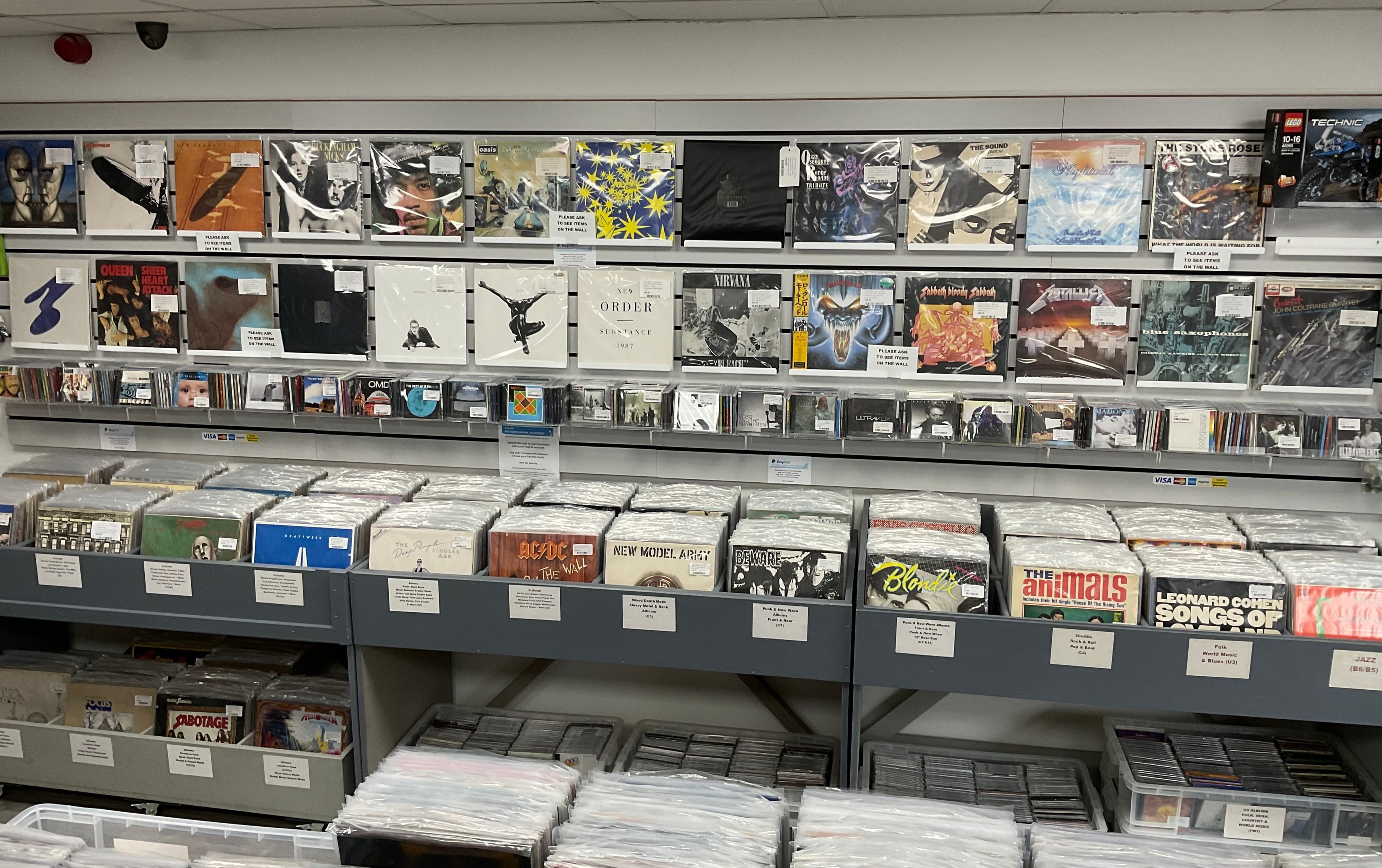 Wall display of vinyl records and CDs inside Music for the Soul Records